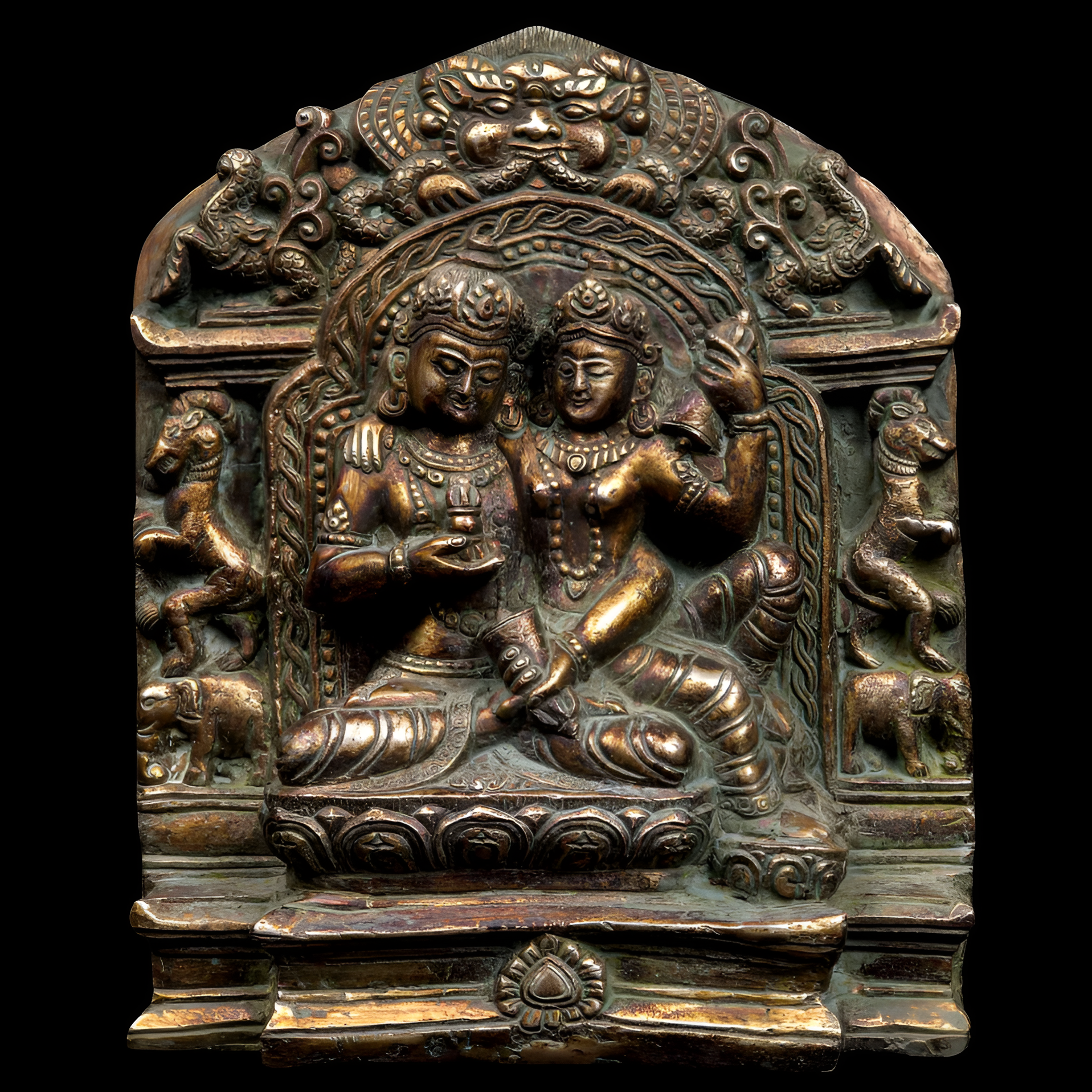 Bronze plaque with two figures in a decorative frame on a black background