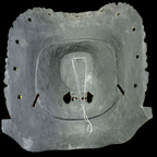 Gray stone structure with a central circular opening on a black background