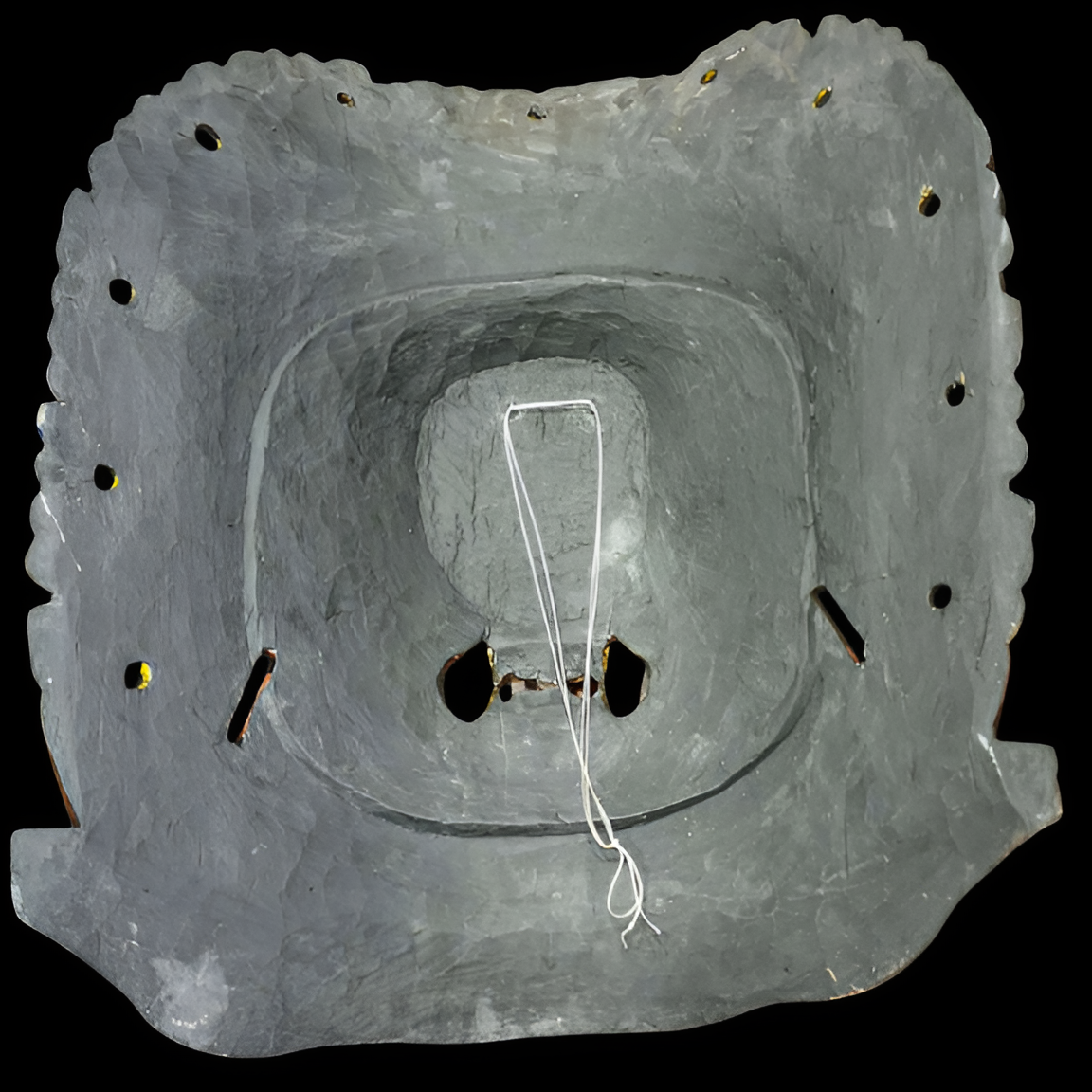 Gray stone structure with a central circular opening on a black background