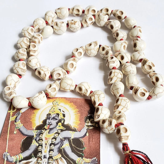 Handcrafted bone skull mala prayer beads with a deity card
