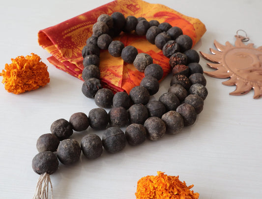 Authentic Rudraksha bead mala necklace with orange marigold flowers and copper sun pendant