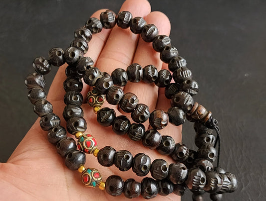 Hand-held traditional black prayer beads mala with colorful accent beads