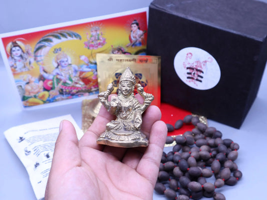 Brass Lakshmi idol with Rudraksha beads and spiritual prayer materials