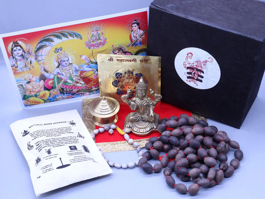 Hindu puja kit with Rudraksha mala, brass deity statue, incense, and spiritual artwork