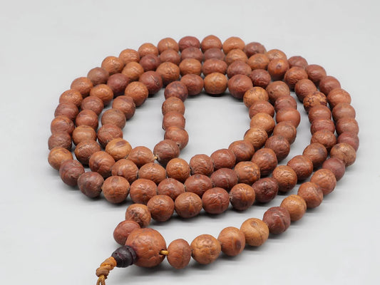 A traditional brown Rudraksha bead mala necklace on a plain white background