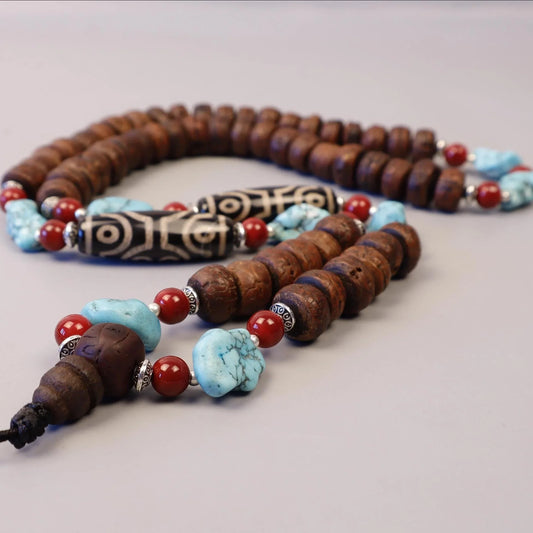 Handmade spiritual mala with brown wooden beads, turquoise stones, and red accents