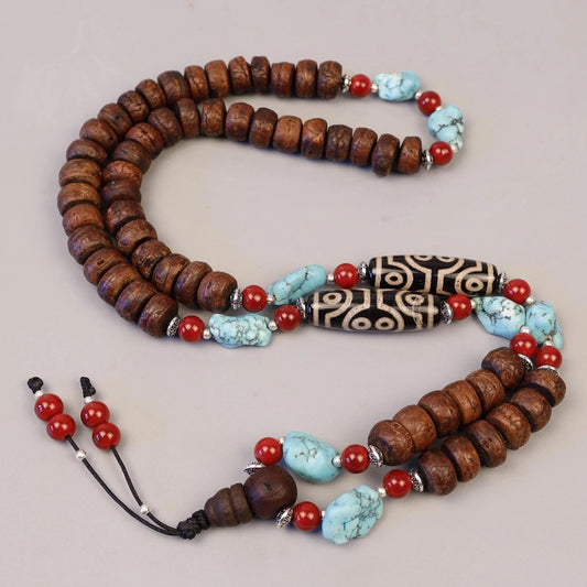 Handcrafted wooden mala necklace with turquoise and red beads and carved bone accents
