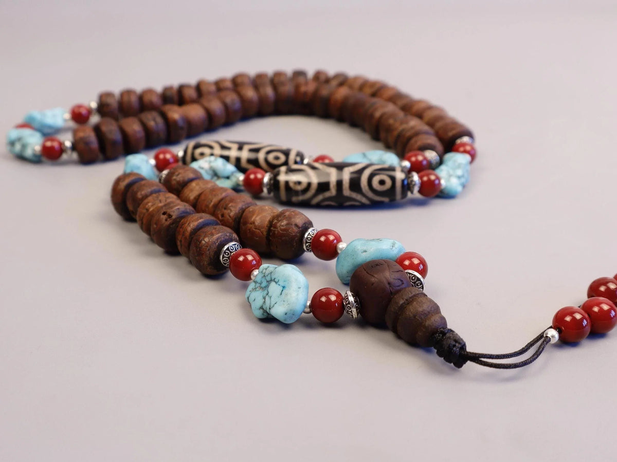 Handmade prayer mala with brown wood beads, turquoise stones, and red accents.