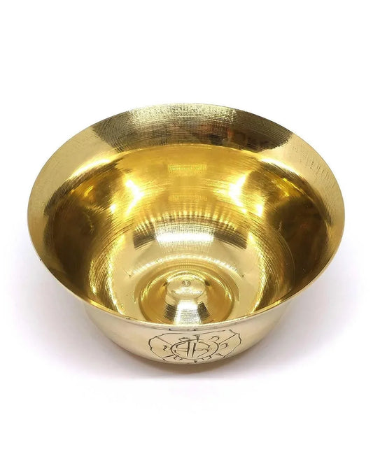 Polished brass singing bowl with engraved symbol on the base