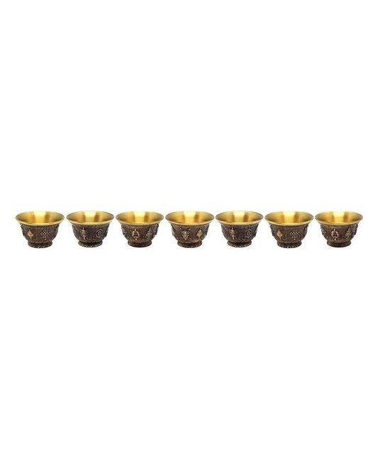 Set of seven traditional brass puja bowls with decorative engravings