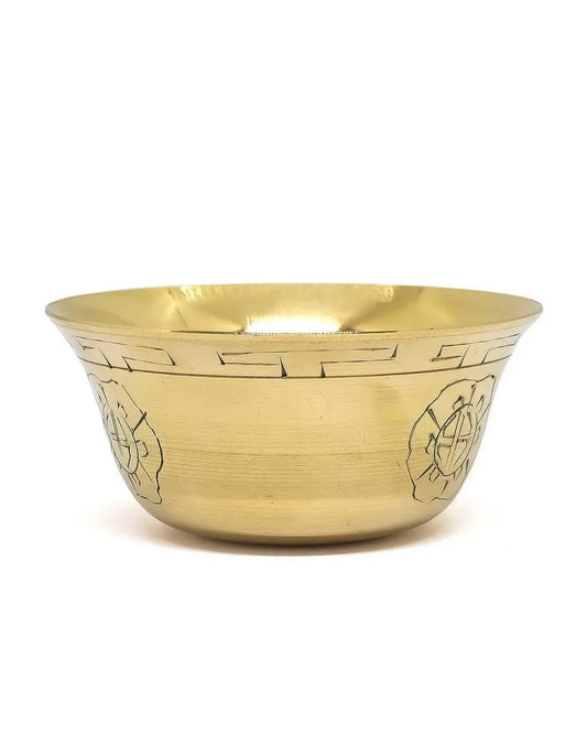 Hand-engraved golden brass singing bowl with traditional Buddhist motifs
