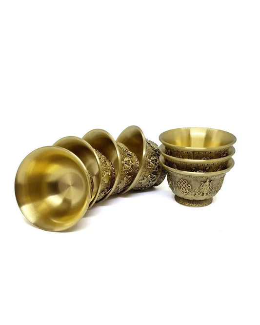 Set of hand-carved brass ritual bowls with intricate traditional patterns