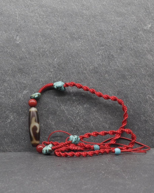 Handcrafted red braided cord bracelet with turquoise and brown marbled beads