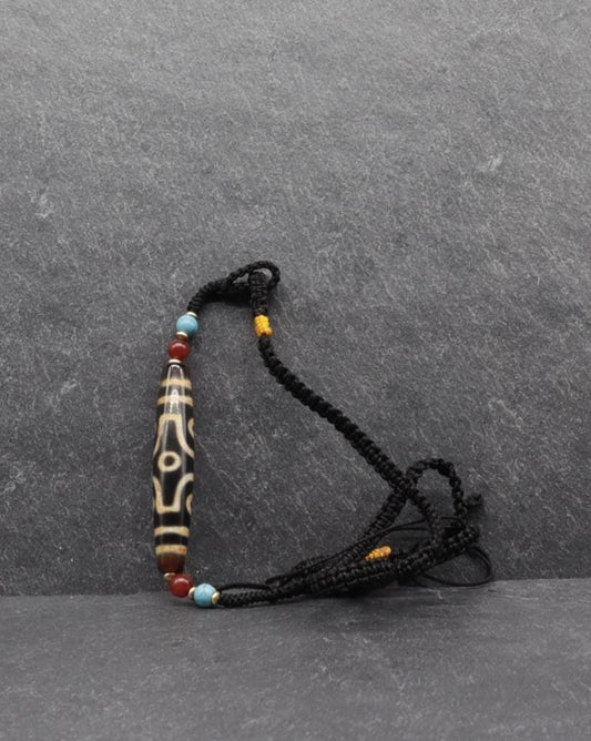 Handcrafted spiritual mala necklace with a carved bone bead, turquoise, and coral accents