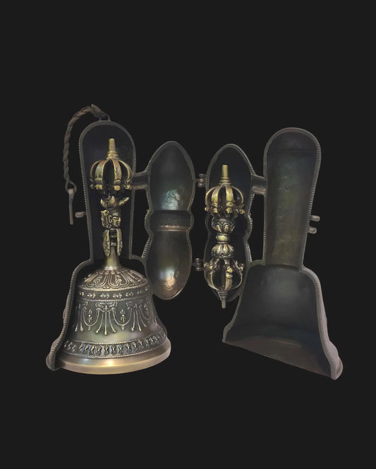 Handcrafted antique bronze ritual bell with ornate crown handle and protective casing