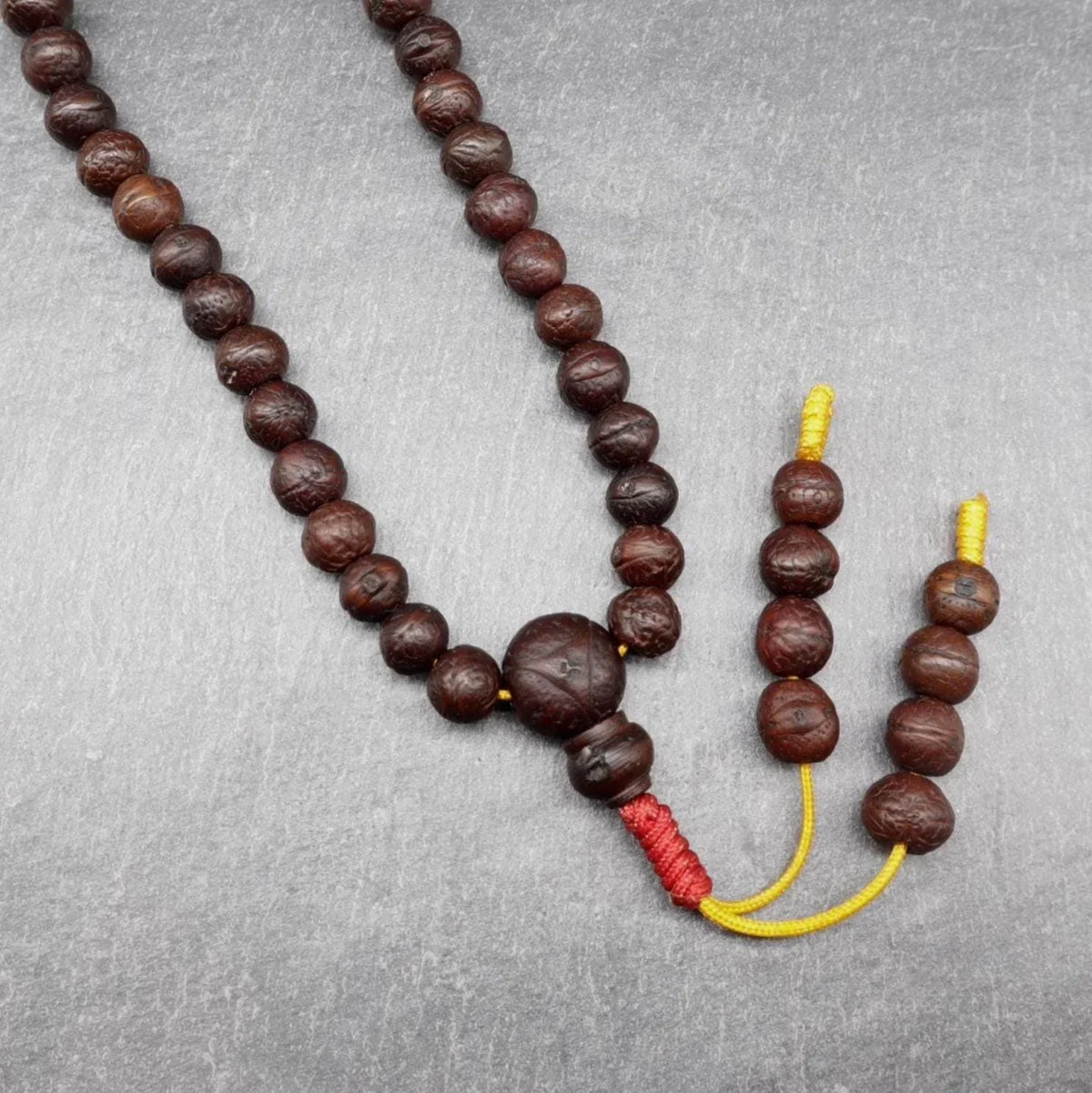 Authentic brown Rudraksha bead mala with traditional red and yellow thread